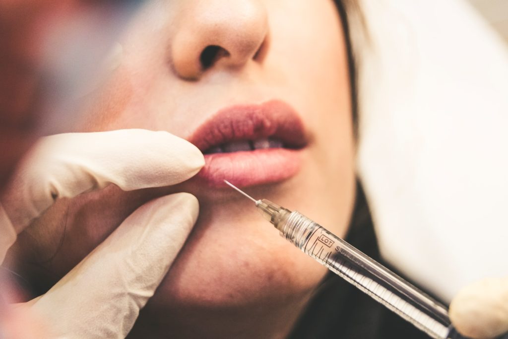 Woman being injected in the lip