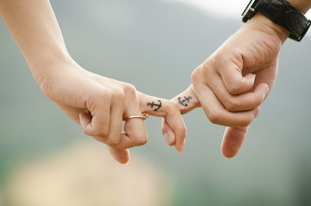 Could holding hands with anchor finger tattoos