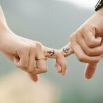 Could holding hands with anchor finger tattoos